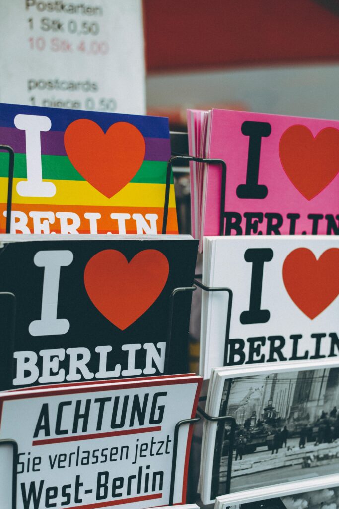 pexels-photo-1268131-1268131 Vibrant postcards featuring 'I Love Berlin' designs in a Berlin shop display.