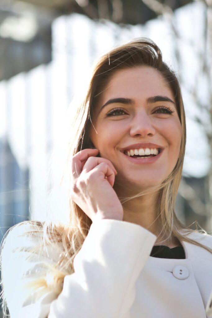 pexels-photo-789822-789822 Confident businesswoman using her tablet and phone, smiling outdoors in sunlight.
